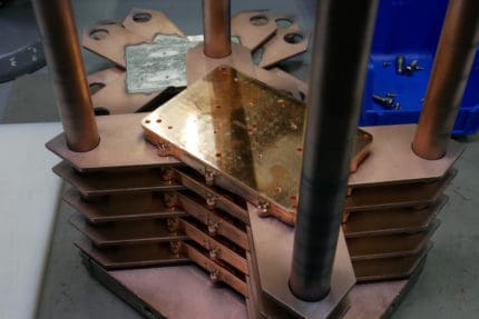 copper parts fixtured for electron beam welding